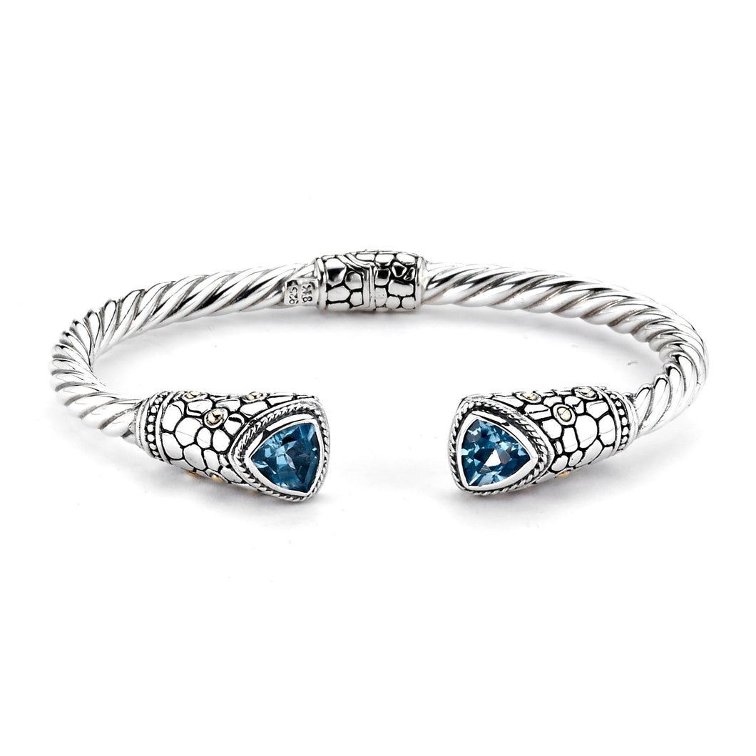 SILVER/18K TWISTED HINGED BANGLE W/ PEBBLE DESIGN BLUE TOPAZ ENDS - MICHAEL K. JEWELERS
